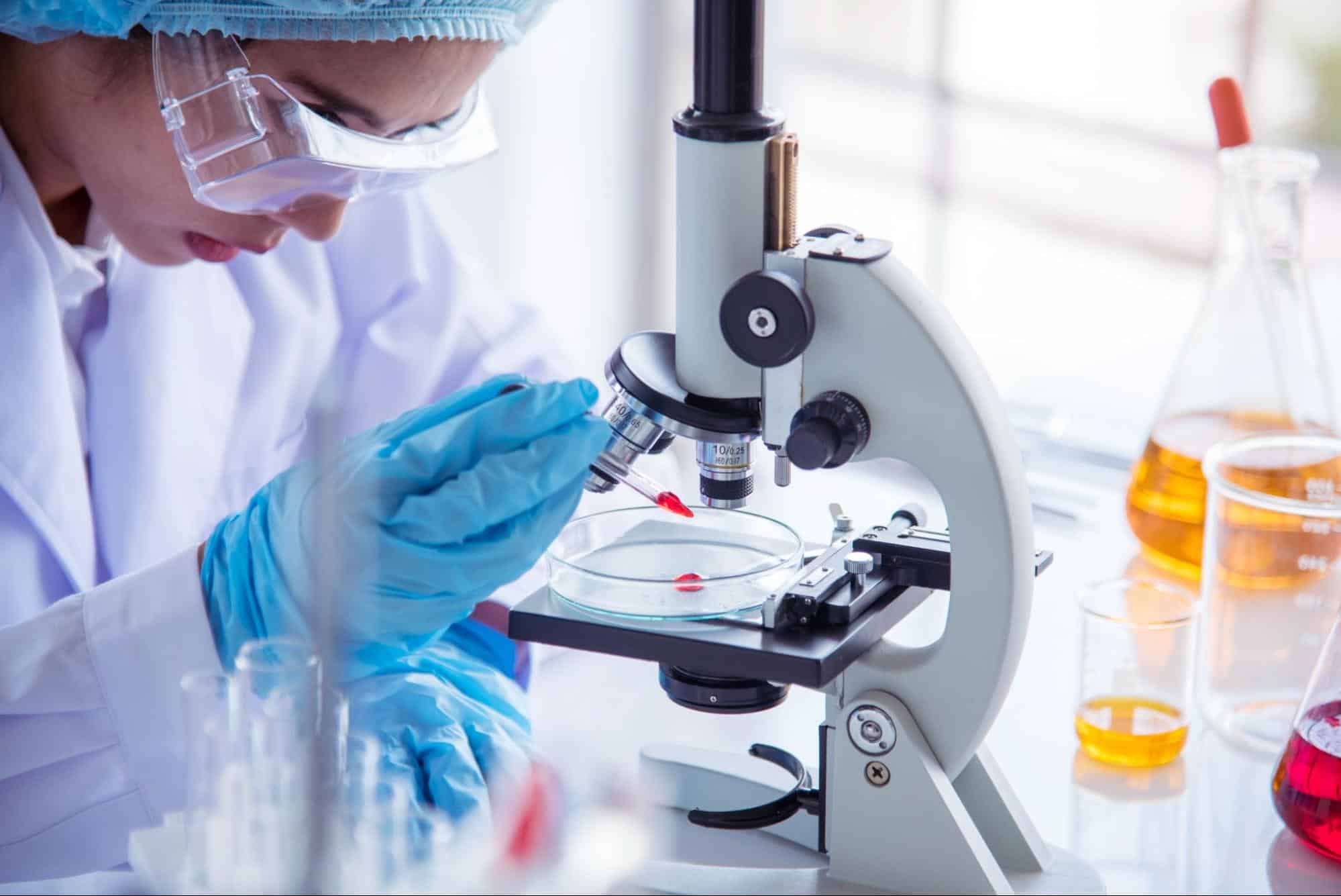 lab technician with microscope